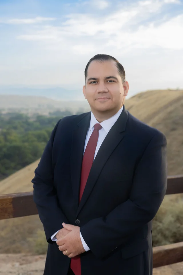 Pedro Naveiras at a hillside overlook with the city and valley behind him